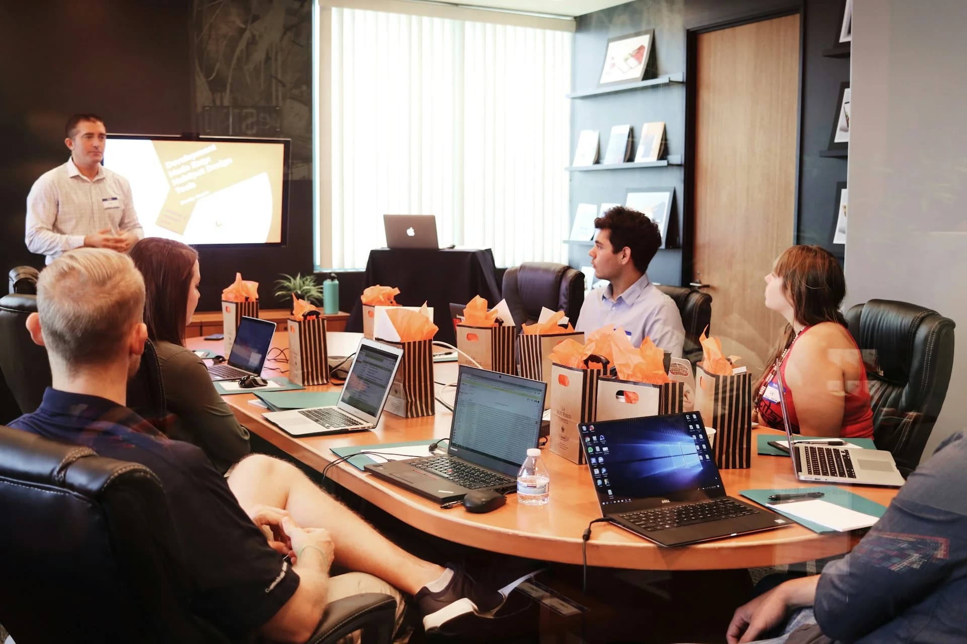 Partners seated at a conference table in discussion